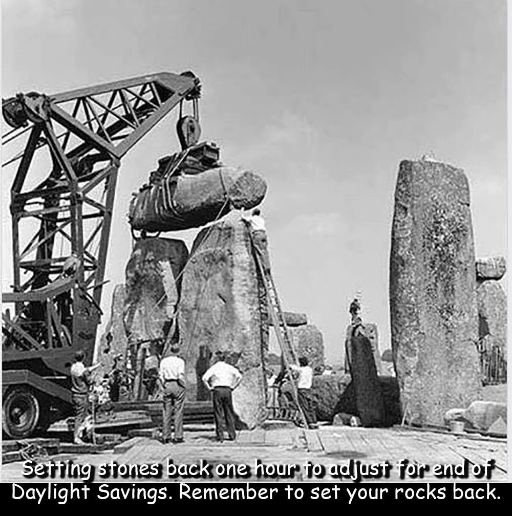 Humorous picture of workers moving stones of Stonehenge with cranes. 